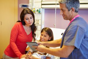 stock-photo-mother-and-daughter-talking-to-consultant-in-hospital-room