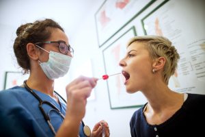 stock-photo-side-close-view-of-female-doctor-specialist-with-face-mask-holding-buccal-cotton-swab-and-test-tube