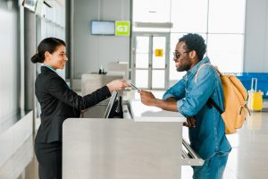 customer service employee at an airport talking to a passanger
