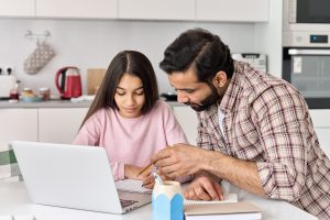 father helping daughter with homework