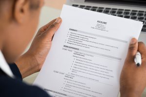 close up of person holding a resume